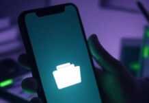 Secure Gallery Lock Apps: Your Fortress for Private Photos & Videos A slightly blurred phone on a cluttered desk, screen glowing with a locked folder icon, a shaky hand's shadow looming over it, and a goofy cartoon padlock with googly eyes in the corner, set in muted purples and grays with neon green accents.