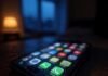 Trending Mobile Apps You Need to Try Before Everyone Else "Blurry neon app icons on a tilted, coffee-stained phone, surrounded by snack crumbs, captured mid-scroll in a rainy US apartment."